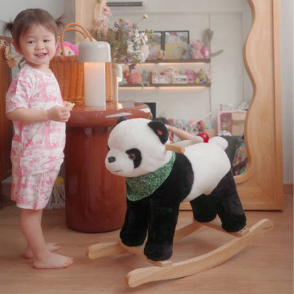 Child wearing pink short sleeve bamboo kids pyjamas set standing beside a panda-shaped rocking toy in a decorated room — soft, eczema-friendly sleepwear.