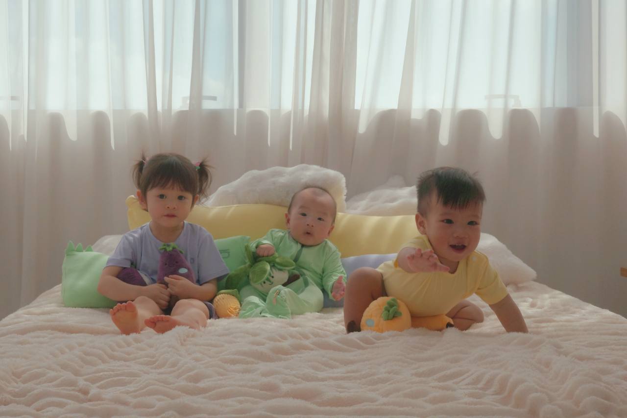 Three children wearing colourful Hae Hae bamboo sets